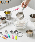Person using stainless steel measuring cup with flour, Nesting Measuring Cups And Spoons Set Made Of Stainless Steel With Soft Silicone Handles