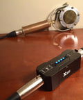 Portable Phantom Power Supply 48V 12V Switch for Condenser and Shotgun Mics, Rechargeable Battery Pack, on wooden table setup.
