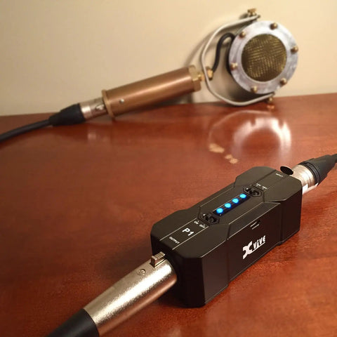 Portable Phantom Power Supply 48V 12V Switch for Condenser and Shotgun Mics, Rechargeable Battery Pack, on wooden table setup.