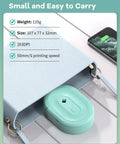 Compact Bluetooth Label Maker With Built In Rechargeable Battery And Ink Free Direct Thermal Printing For Effortless Home Organization And Straight Up Reliable Daily Labeling Jobs In Cool Green placed inside a light blue bag.