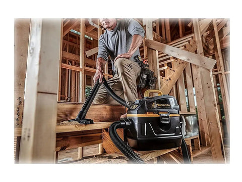 Beast Series 5 Gallon Wet Dry Vacuum With 5.5 HP Motor, 1-7/8 Inch Hose being used on construction site woodwork cleanup.