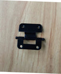 Black self closing cabinet hinges mounted on wood surface