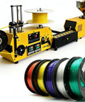 Kickass High Precision Desktop Filament Extruder Machine with yellow auto winding system and colorful spools for 3D printing.