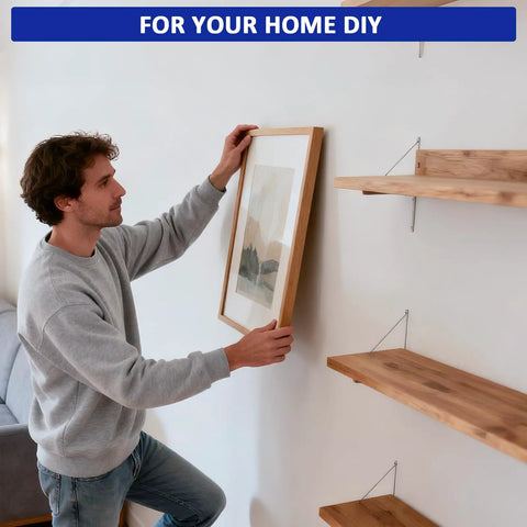 Person using Heavy Duty Drywall Toggle Bolt Set Kit With 28 Pieces In Three Sizes to hang a picture on the wall.