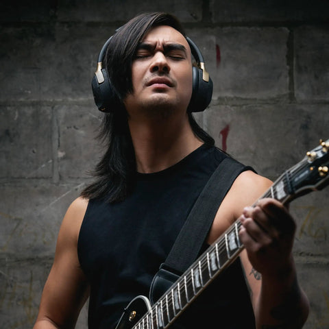 Person playing guitar wearing Spark NEO Wireless Guitar Headphone Amp And AI Powered Guitar Rig For Dope Audio Experience