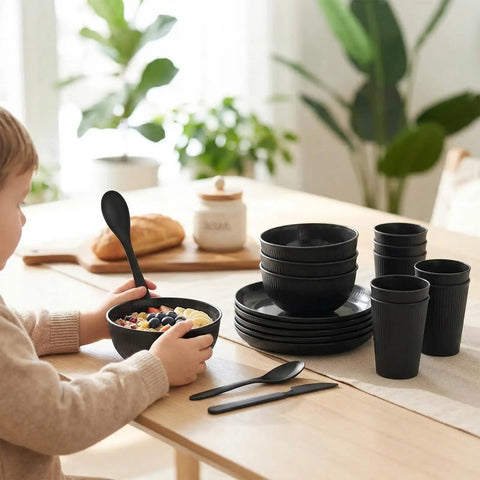 Child eating from Built Tough 36 Piece Wheat Straw Dinnerware Set For 6 No Fuss Unbreakable Bowls Plates And Cups, black set on table.