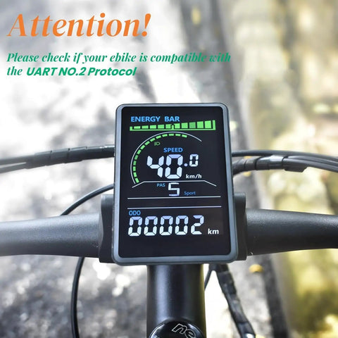 Close-up of Ebike Display M6C UART No 2 Protocol LCD Cycling Computer on handlebars showing speed and distance.