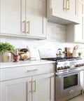 Modern kitchen with 10 Pack Brushed Gold Cabinet Pulls 5 Inch 128mm Solid Heavy Duty Zinc Alloy Drawer Handles installed on white cabinets.
