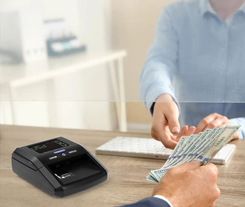 Portable Counterfeit Money Detector With LCD Display, Infrared And Magnetic Detection in use at a cash desk