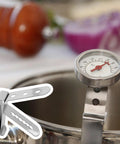 Stainless Steel Thermometer Probe Clip Holder For BBQ And Grill Three Hole Ambient Temperature Clamp in use over a pot.