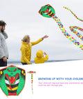 Family flying Long Snake Kite With Gold Foil Detailing Handcrafted Ophidian Animal Kite at beach on windy day