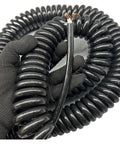 Rock Solid Retractable Coiled Power Cord with Copper Core and Hella Tough Plastic Body for Smooth Spring Spiral Stretch to 20 Meters, showing coiled cable held in gloved hand.