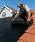 Installing Pro Grade Self Adhesive Waterproof Roofing Membrane Roll Peel And Stick Leak Proof Sealant Tape on a sloped roof.
