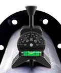 Anblak pipe center finder, black Y-shaped tool with dial gauge and green bubble level mounted on a pipe.