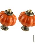 Two orange pumpkin ceramic cabinet knobs with screws, vintage drawer pulls for closets, cabinets, and dressers.