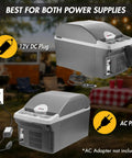 Portable 14 Liter Thermoelectric Cooler Warmer With 12 Volt DC Power For Car RV And Camping Use in outdoor setting with power supplies visible.