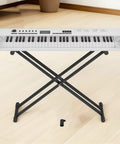 Digital piano on stand with 8 Pack Keyboard Stand Feet Replacement Caps for Digital Pianos and Keyboards Shock Absorbing Non Marking Leg Protectors visible