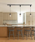 Slick Adjustable Black Track Lighting Pendants Pack Of 3 illuminating modern kitchen with clear glass shades.