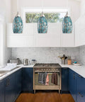 Handblown Blue Art Glass Pendant Light With Brushed Nickel Finish hanging in kitchen over island