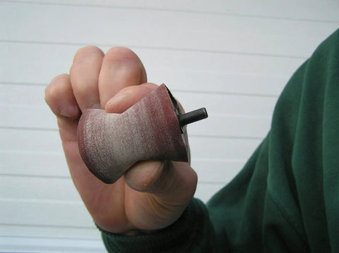 Hand holding the Guinevere Basic Sanding Kit for Woodworking and Finishing rotary tool attachment for shaping curves.
