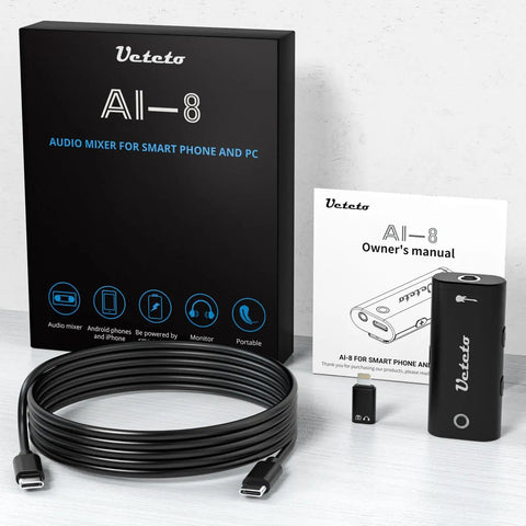 Guitar Audio Interface Plug And Play Portable Recording Sound Card For Live Streaming On IPhone Ipad And Android Phones And Tablets No Driver Needed OTG Ready with accessories and packaging on table.