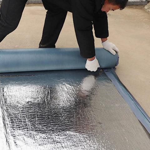 Premium Ultra Heavy Duty Self Adhesive Waterproof Roof Patch Tape For Asphalt Shingles And Leaks Hella Tough being rolled out for application.