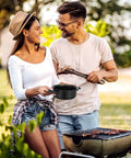 Couple cooking outdoors with Travel Ready 13 Piece Nonstick Cookware Set With Lightweight Cast Iron Pots And Pans
