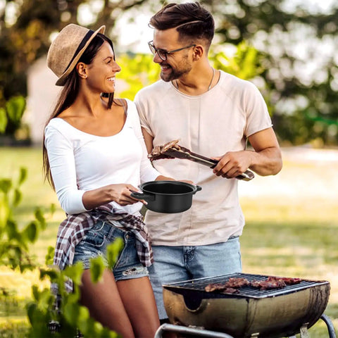 Couple cooking outdoors with Travel Ready 13 Piece Nonstick Cookware Set With Lightweight Cast Iron Pots And Pans