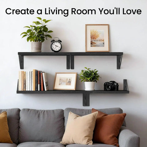 Straight Up Sleek Wall Mounted Floating Shelves In Matte Black Solid Set Of Four above a gray couch with books and decor.
