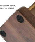 Close-up of non-slip foot pads on Boss Grade Wood And Copper Espresso Tamper Station for desktop protection.