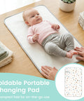 Baby on Portable Baby Changing Pad With Waterproof, Wipeable Surface, Compact Fold, Raindrops Design, For On The Go Parents
