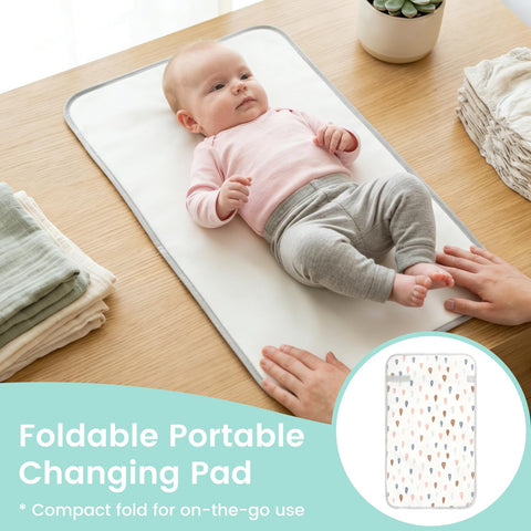 Baby on Portable Baby Changing Pad With Waterproof, Wipeable Surface, Compact Fold, Raindrops Design, For On The Go Parents