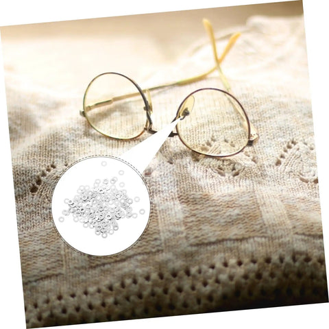 Metal Flat Washers For Eyeglasses Replacement Gaskets Rimless Glasses Quick Repair Kit displayed next to eyeglass frames