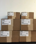 Stack of boxed Duct Sensor Housing 4098-9755 for Fire Safety Systems, labeled packages ready for shipping.