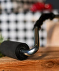 Pro Grade Heavy Duty High Pressure Rubber J Roller with curved handle on wooden surface, ideal for laminate and veneer glue application.