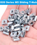 Hand holding 100Pcs M5 Sliding T Nuts for 20X20 Aluminum Extrusion 6mm T Slot Easy End Load Install Metric M5 Thread