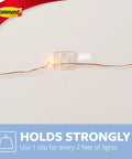 Clear Mini Light Clips For Damage-Free Decorating securing light on wall, showing clip holding string light firmly.