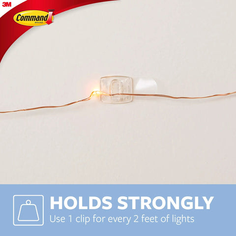 Clear Mini Light Clips For Damage-Free Decorating securing light on wall, showing clip holding string light firmly.