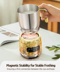 Detachable Milk Frother With Four Temperature Settings Delivers Barista Style Foam For Hot Or Cold Drinks Five In One Frothing And Heating Options Dishwasher Safe 400ml Perfect For Latte Cappuccino Hot Chocolate, showing a stainless steel cup on a decorative base
