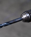 Onyx 21pc TurboStep HSS Drill Bit Set With Patented Stepped Tip attached to drill, close-up view, metalworking focus, 1/16 to 3/8 Inch
