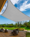 Curved Sun Shade Sail 20x26 Grey Outdoor Canopy over patio with trees, UV blocking permeable 185 GSM HDPE, stainless D ring corners visible.