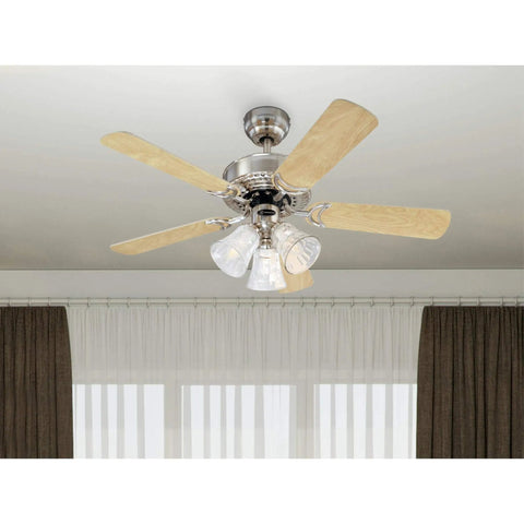 Newtown 42 Inch Indoor LED Ceiling Fan With Light Brushed Nickel Finished With Reversible Light Maple And Bird's Eye Maple Blades Combo Mount Ready For Small Rooms Up To 100 Sq Ft Energy Efficient LED Light Kit With Water Glass. Shown installed in a room with curtains.