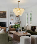 23 Inch 9 Light Gold Glass Chandelier 3 Tier Round Crystal Pendant Light Height Adjustable illuminating a stylish living room.