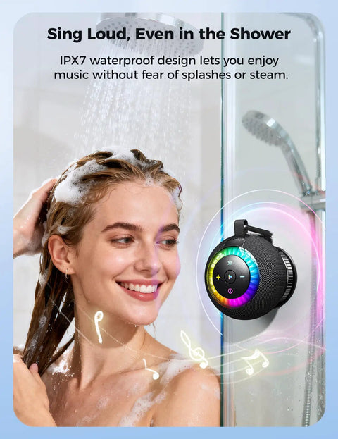 Woman using Waterproof Portable Shower Speaker with 360 Degree Sound and RGB Lights in bathroom, mounted with suction cup.