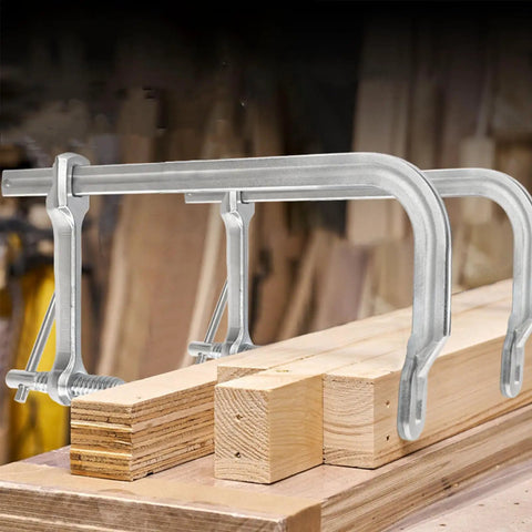 Heavy Duty F Clamp With Drop Forged Steel Construction securing wood planks in workshop, showcasing adjustable rotating pad