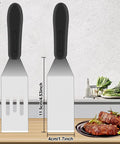 Two-piece stainless steel slotted spatula set with black handles for kitchen use, front view