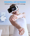 Person using VR headset in front of Massive WiFi Coverage Extender Boost With Dual Band Five GHz And Two Point Four GHz Repeater.