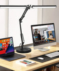 Two In One LED Desk Lamp With Dual Heads And Clamp Or Base Mount, 24W Eye Care Workbench Light on office desk with computer setup.