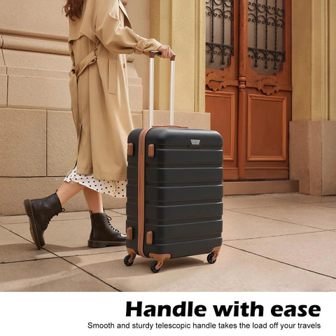 Front view of black hard-shell spinner luggage with tan trim, telescoping handle and four wheels.