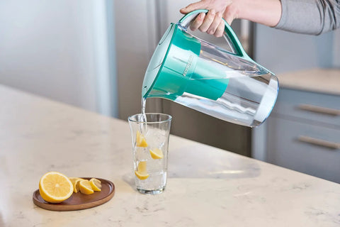 Pouring water from a pitcher using EcoFilter Replacement Filter No Plastic Shell For Cleaner Water That Tastes Great By Reducing Chlorine Smell And Taste Eco Friendly BPA Free NSF Certified 2 Pack